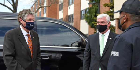 Gov. Dan McKee (l), RIPTA CEO Scott Avedisian (center), and RIPTA driver Jesus Castro (r) outside D'Evan Manor on Cranston Street where RIPTA was delivering a hot lunch to a resident for Meals one Wheels of Rhode Island.